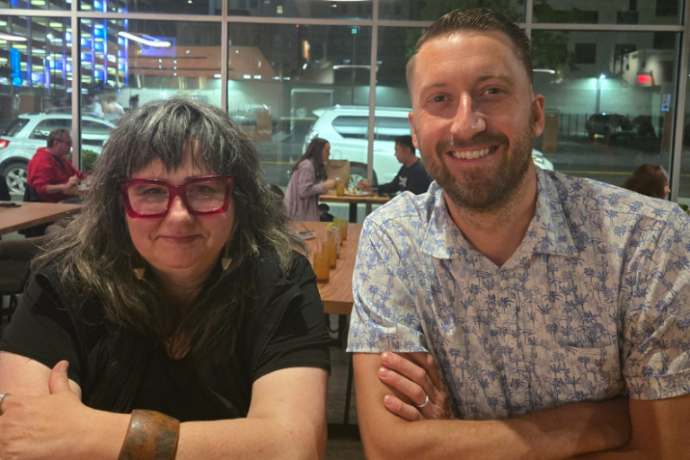 Bevin Brooks of Lionberry and Eric Myers of Myers Mushrooms sitting and smiling with their arms crossed.